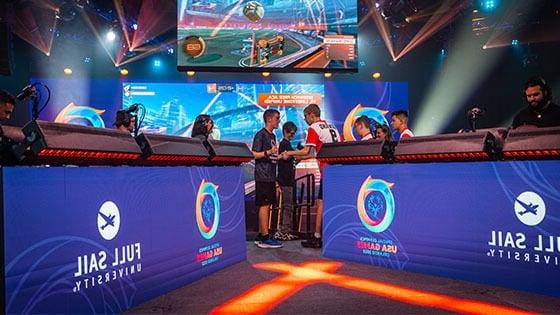 Two Special Olympians shaking hands after a match on stage at the Full Sail University Orlando Health Fortress.