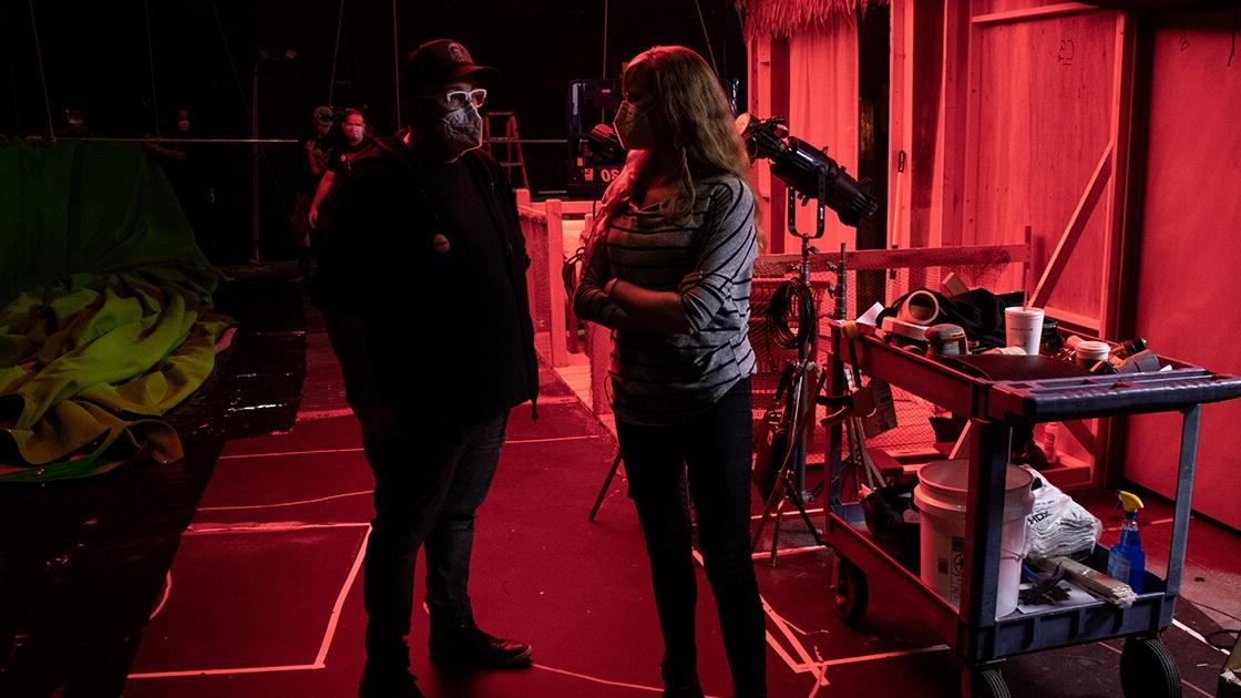 A man and a woman stand next to each other surrounded by cameras and film 设备 on a sound stage